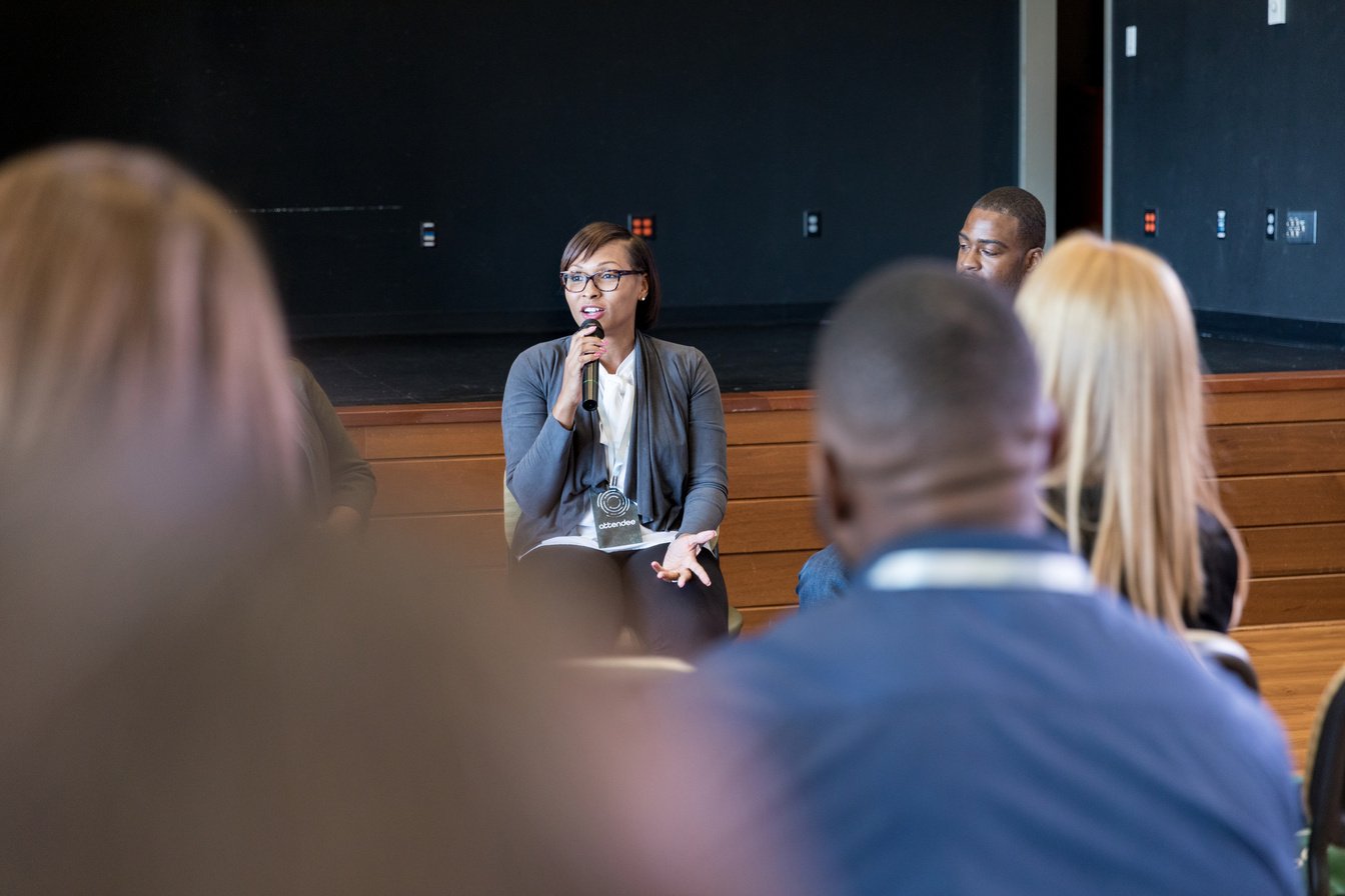 Mid adult female panelist answers question from audience